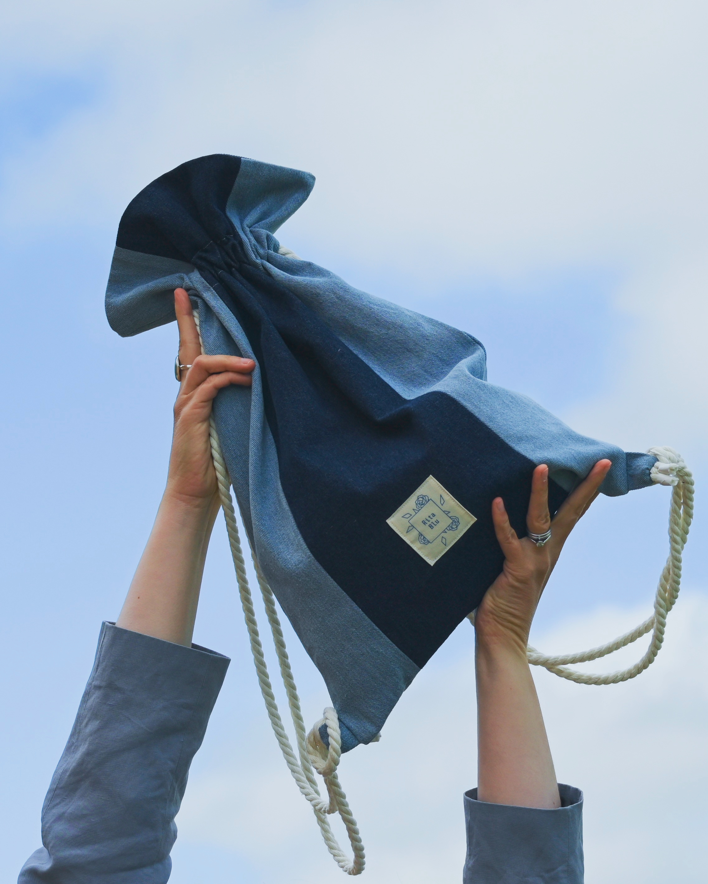 Azuri Backpack held up in the air.